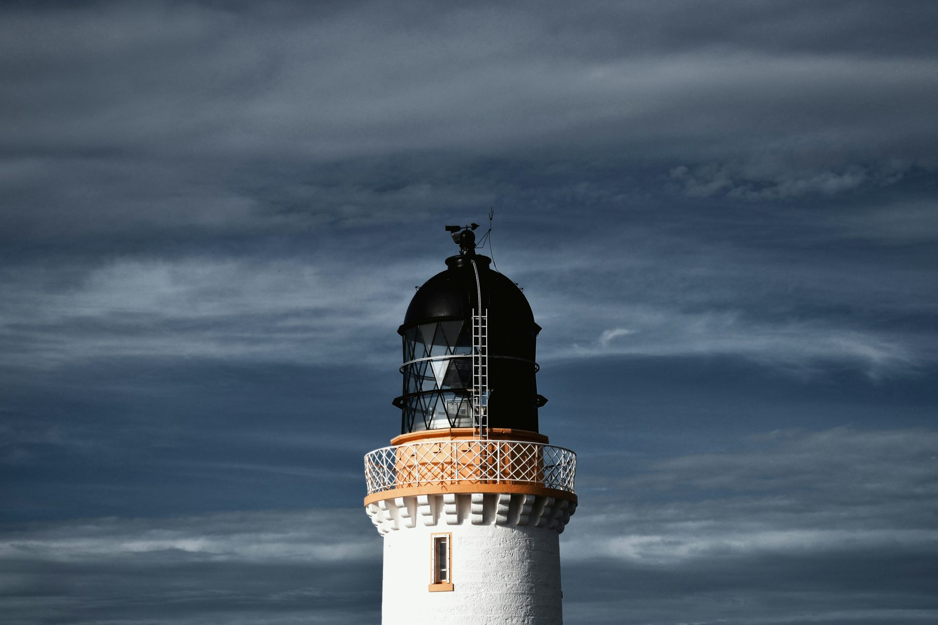 a lighthouse with a cloudy sky