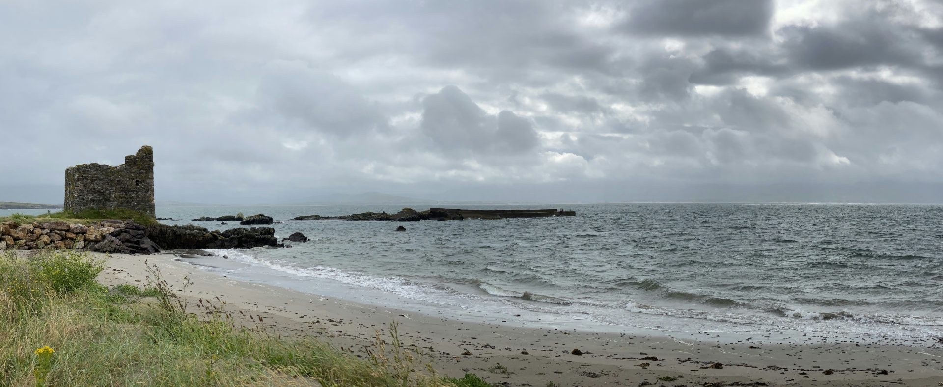 a beach with a tower in the middle of it